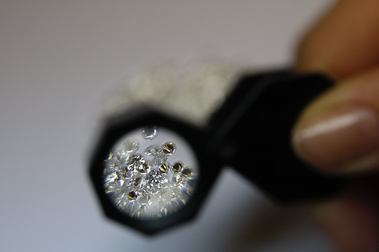 magnifying glass looking at diamonds